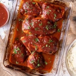 Oven BBQ Chicken in a baking dish on a cloth.