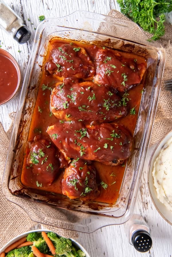 Oven BBQ Chicken in a baking dish on a cloth.