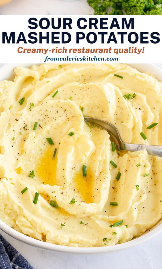 A close up of Sour Cream Mashed Potatoes in a bowl with a spoon with overlay text.