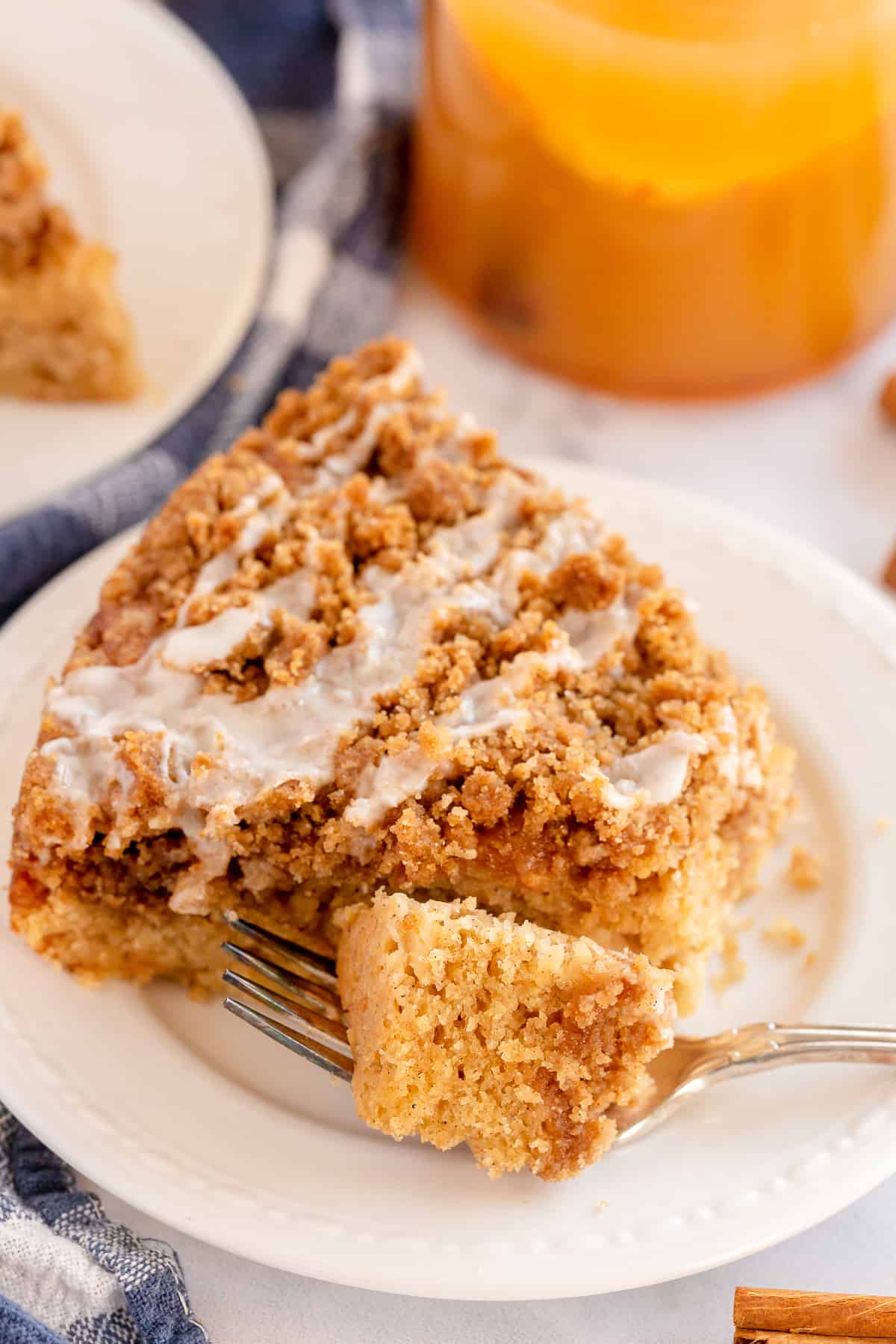 A fork on a plate with a slice of coffee cake.