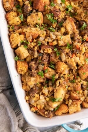 A close up of cornbread stuffing in a blue dish.