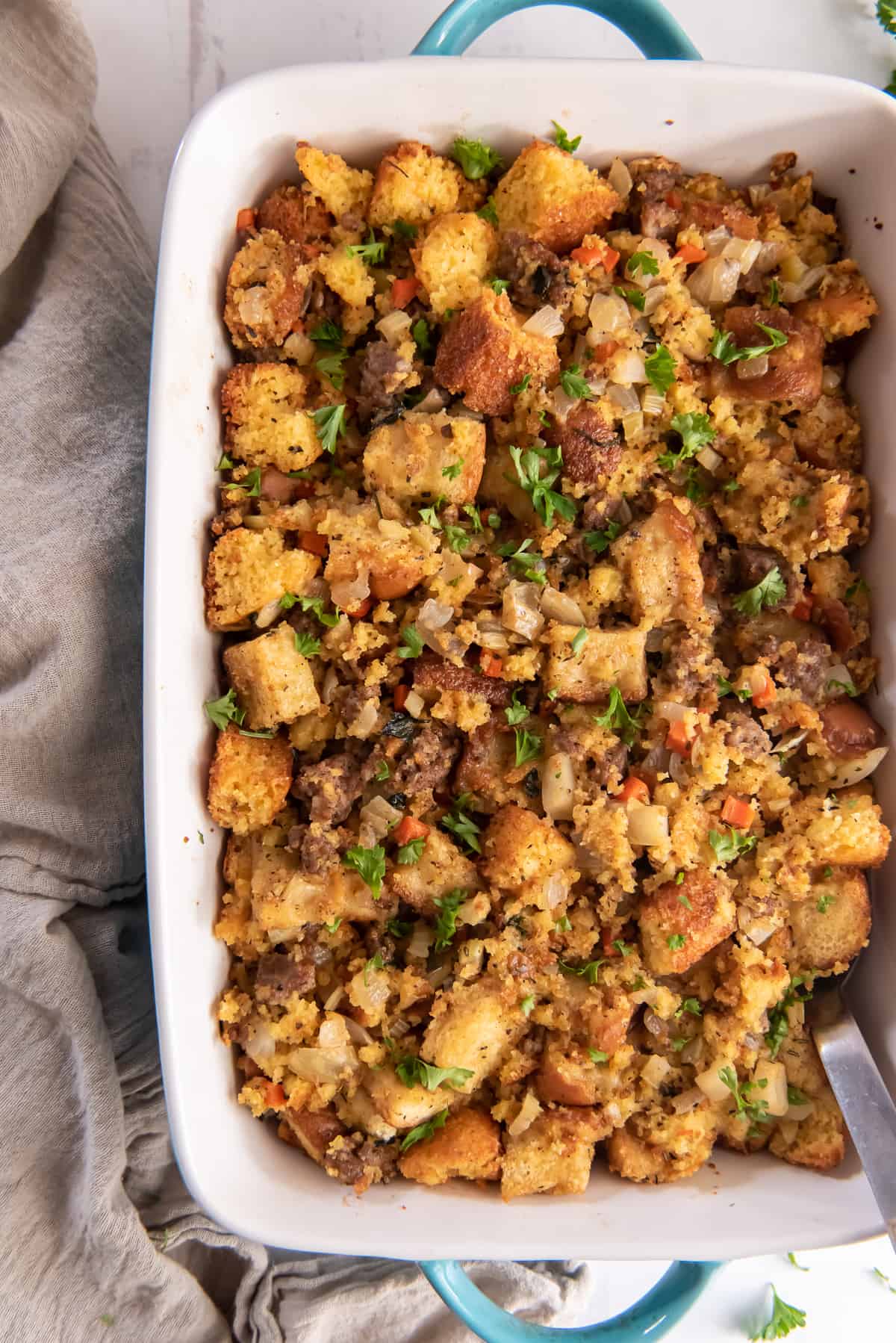 Cornbread dressing in a blue dish shot from over the top.