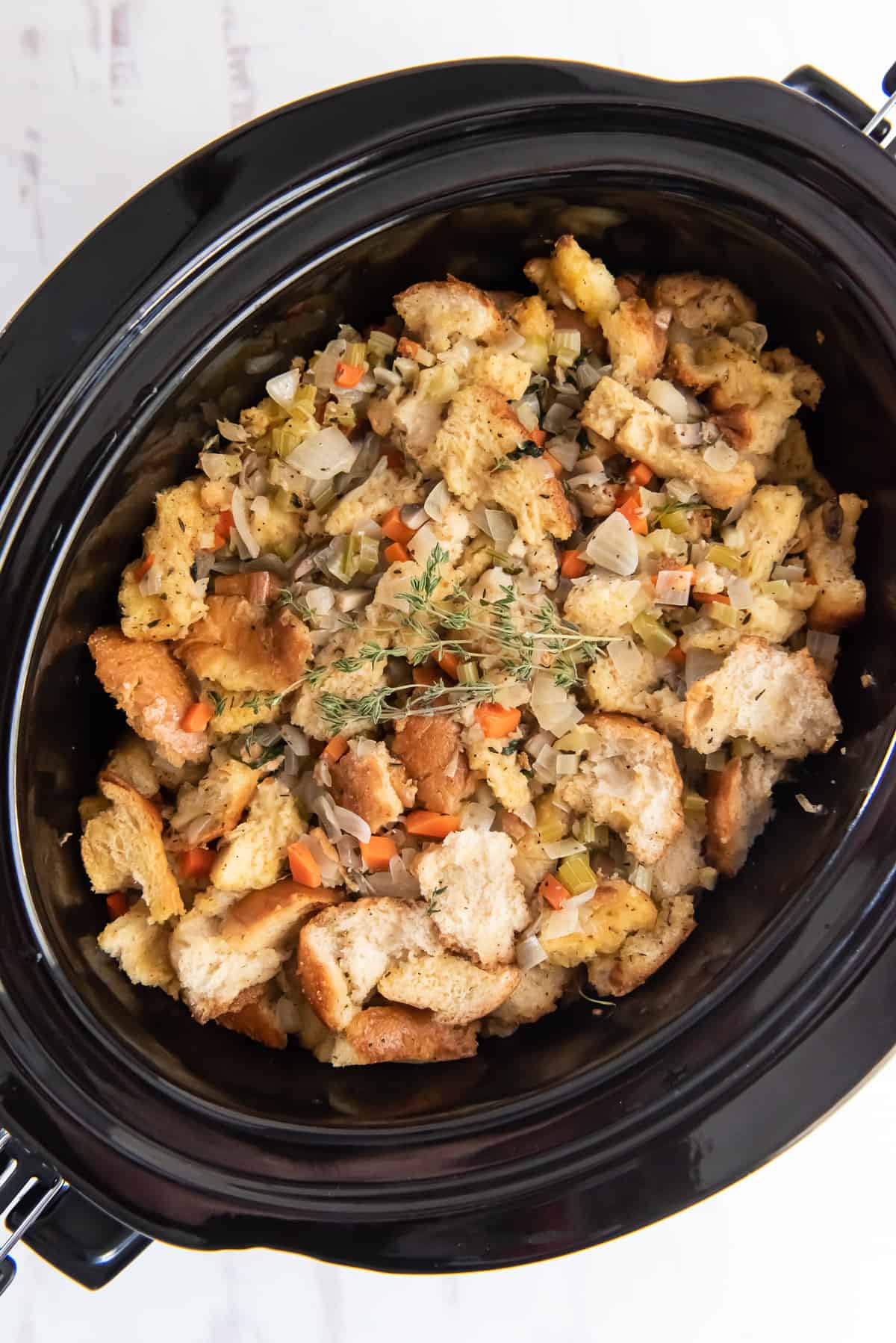An over the top shot of stuffing in a slow cooker.