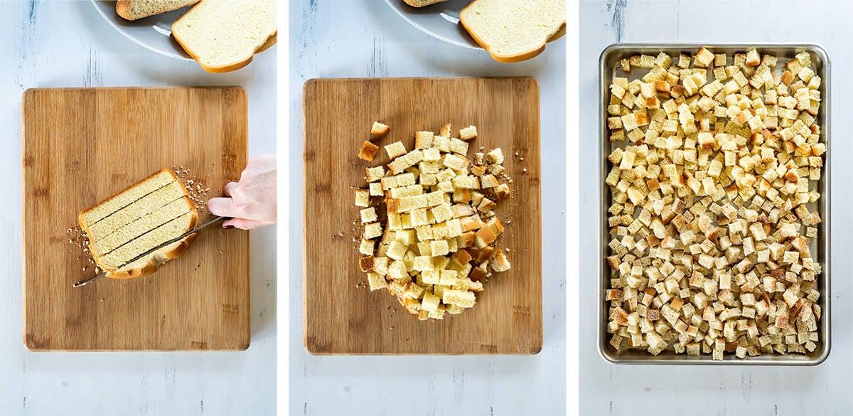 Sandwich bread is sliced into cubes and placed on a baking sheet.