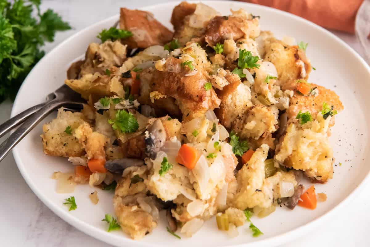Bread stuffing on a white plate with a fork.