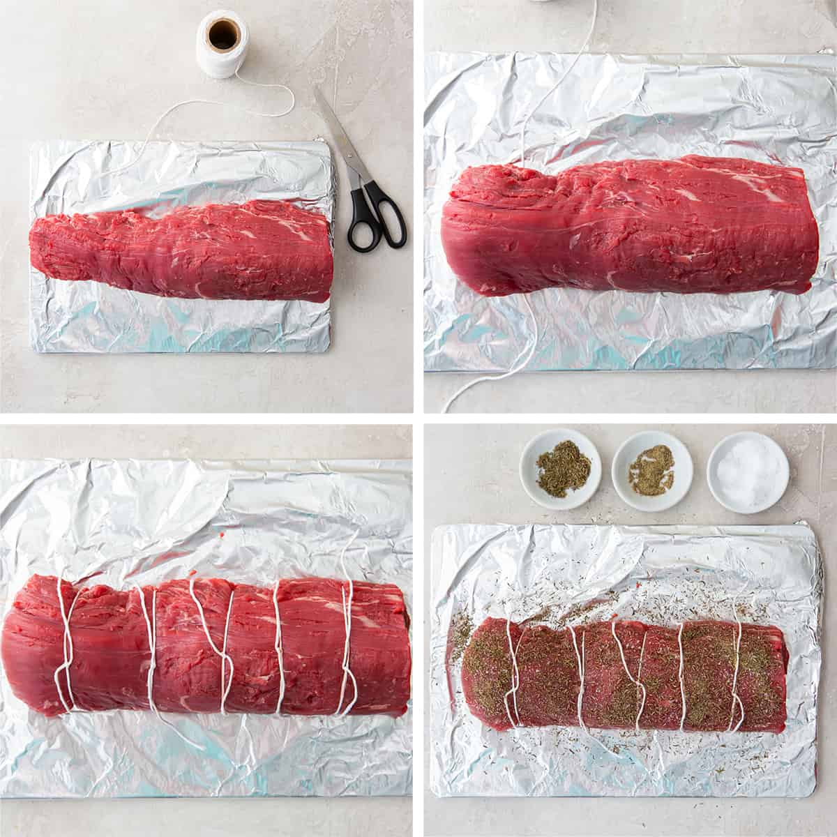 A beef tenderloin tied with kitchen twine and seasoned.
