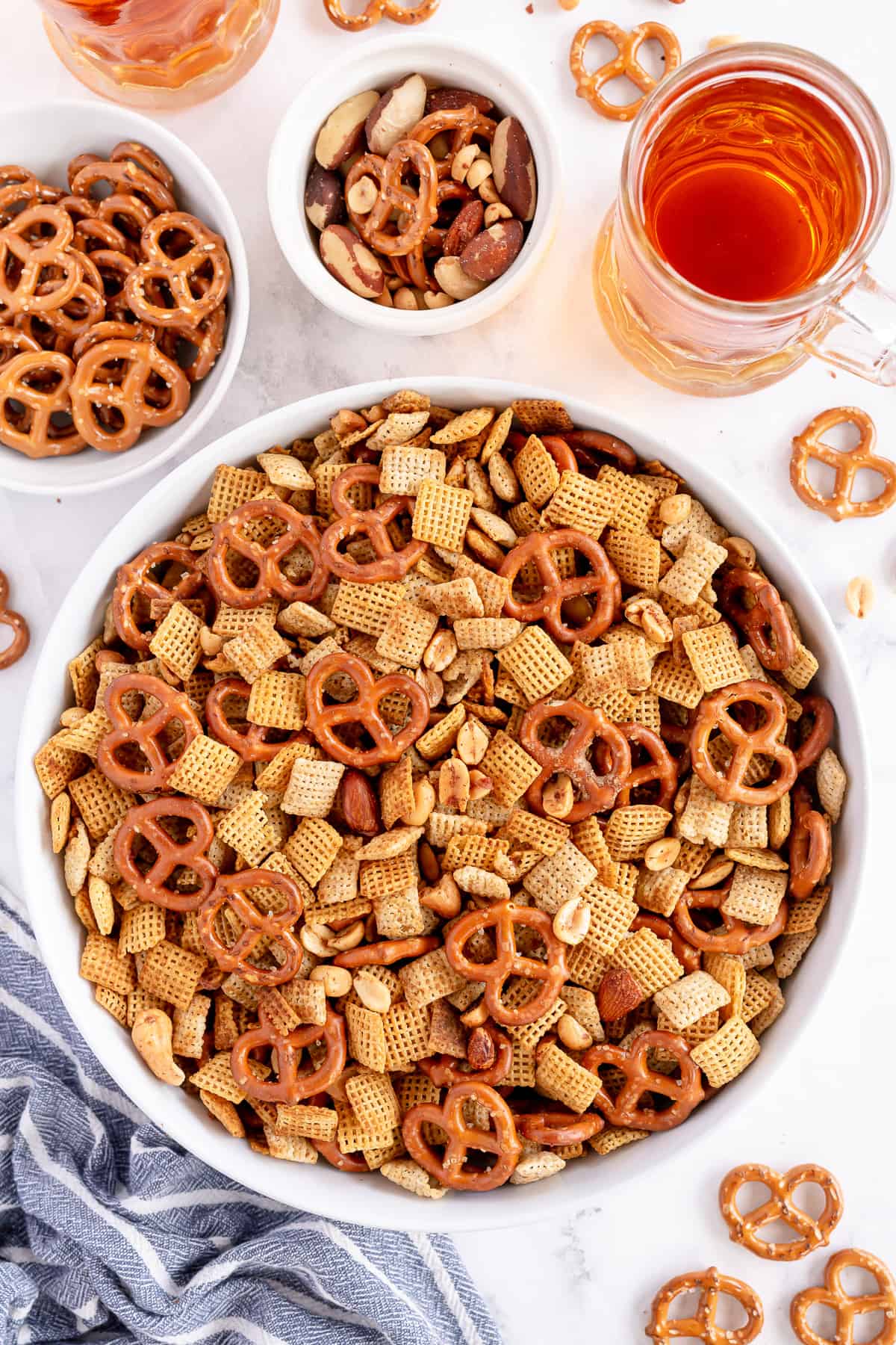An over the top shot of Chex Mix in a large white bowl.