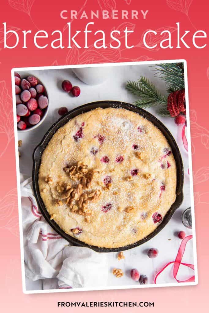Cranberry breakfast cake in a cast iron skillet with text overlay.