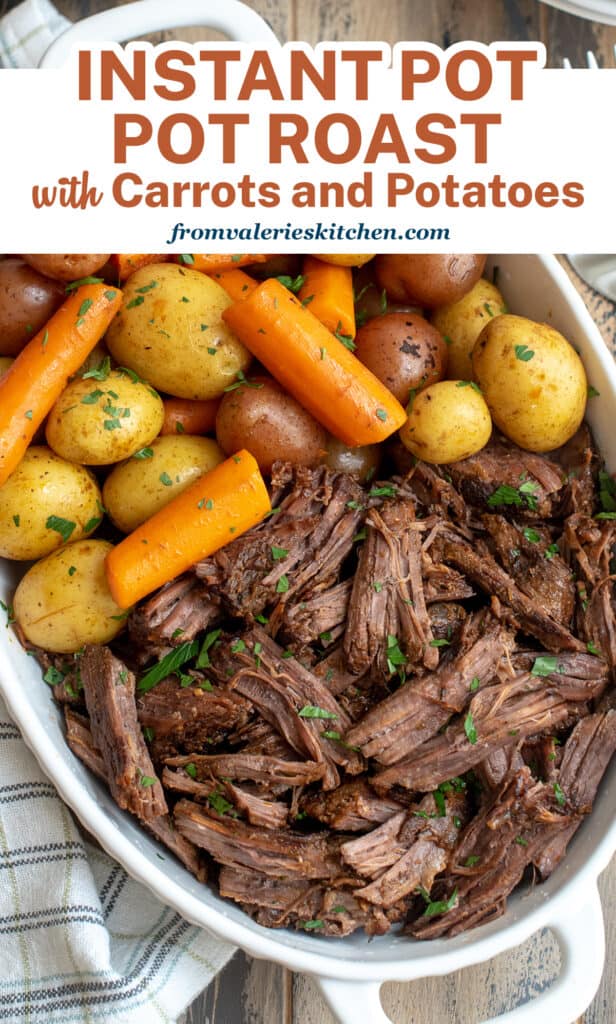 An over the top shot of pot roast with carrots and potatoes in a serving dish with overlay text.