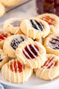 A pile of Jam Thumbprint Cookies topped with glaze.