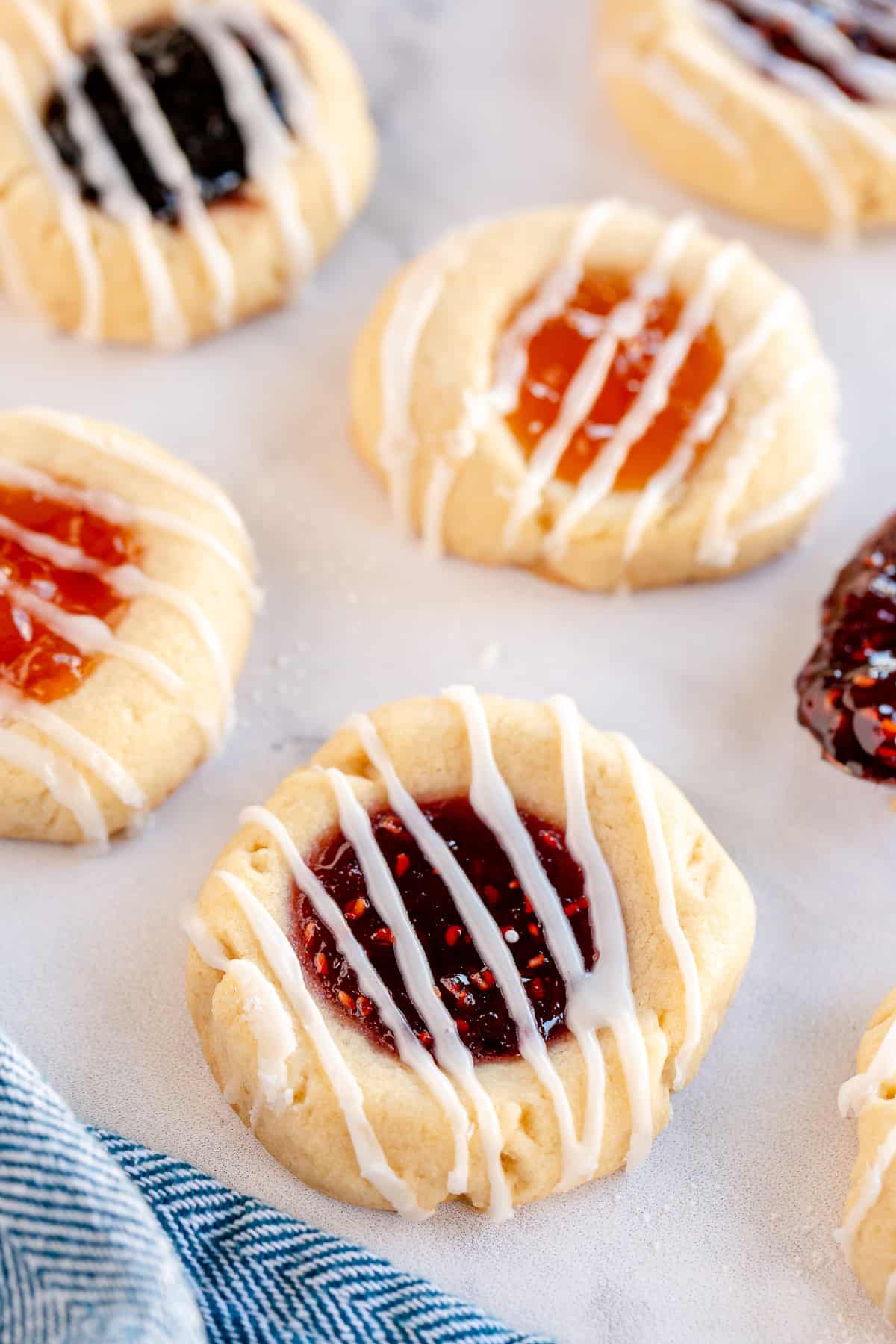 Jam Thumbprint Cookies topped with glaze.