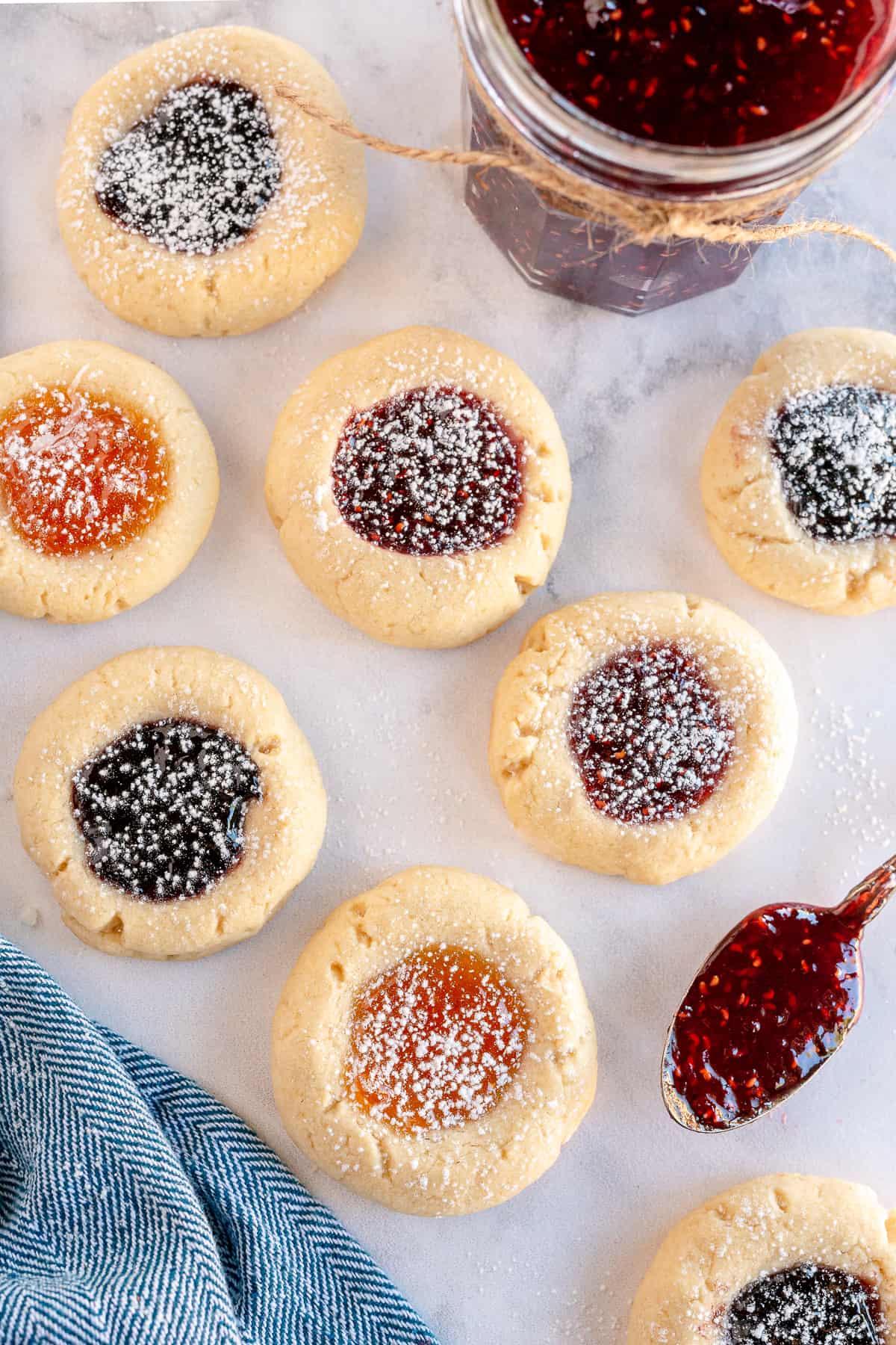 Jam filled thumbprints dusted with powdered sugar.