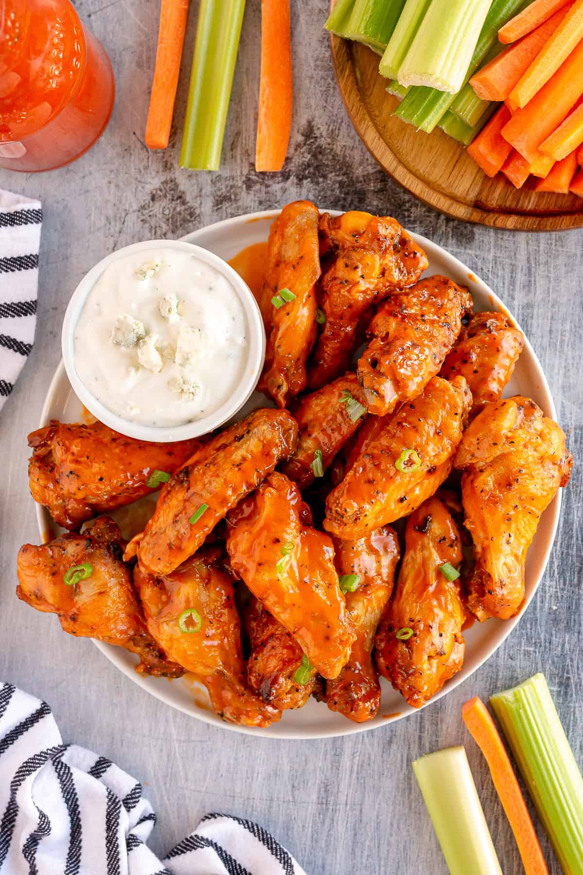 Buffalo chicken wings on a platter with blue cheese ranch dip.