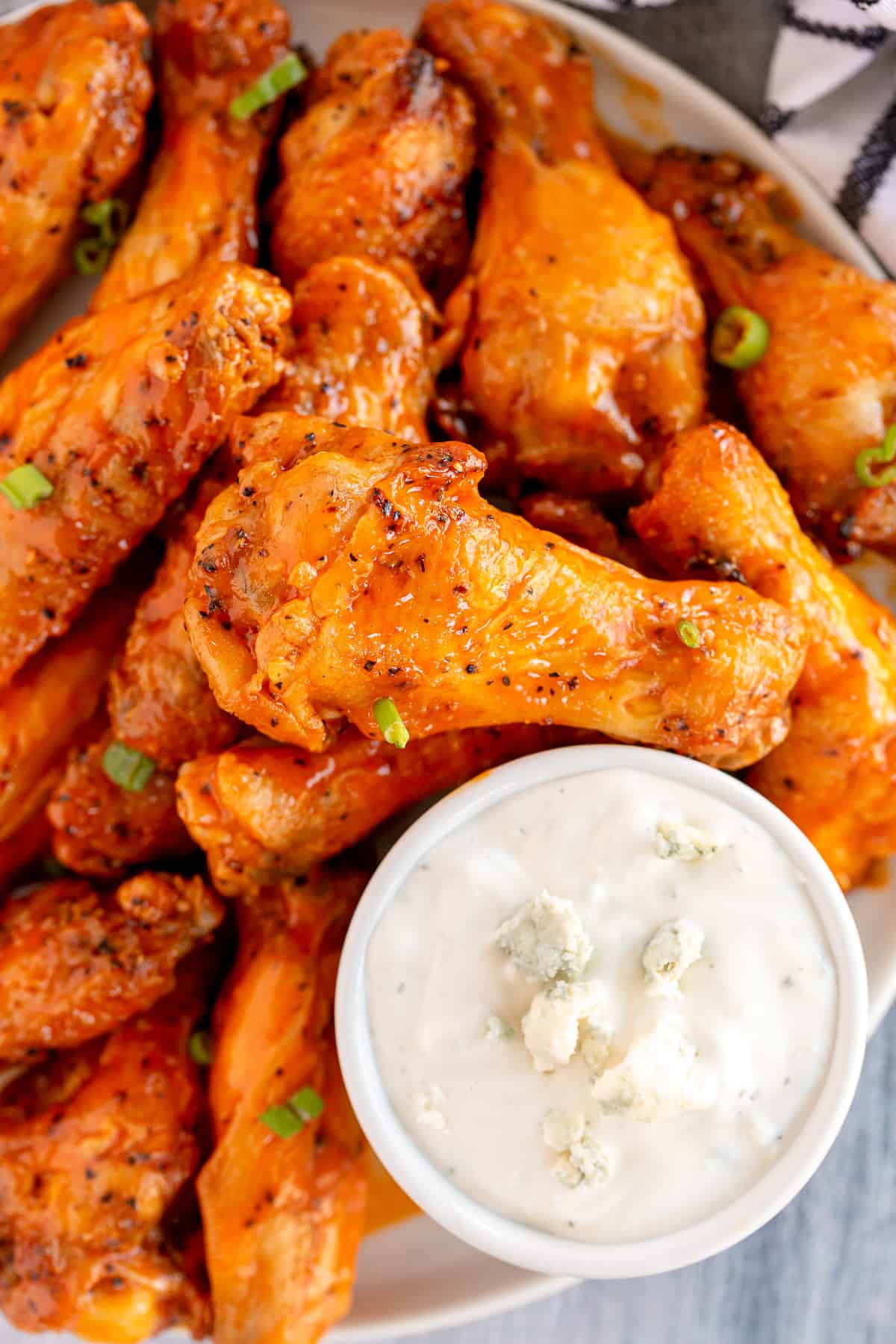 An over the top shot of Buffalo chicken wings and a small bowl of blue cheese ranch dip.