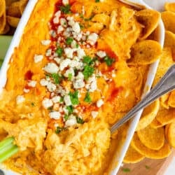 An over the top shot of Buffalo Chicken Dip topped with green onion and blue cheese.