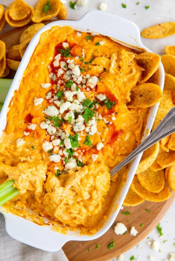 An over the top shot of Buffalo Chicken Dip topped with green onion and blue cheese.
