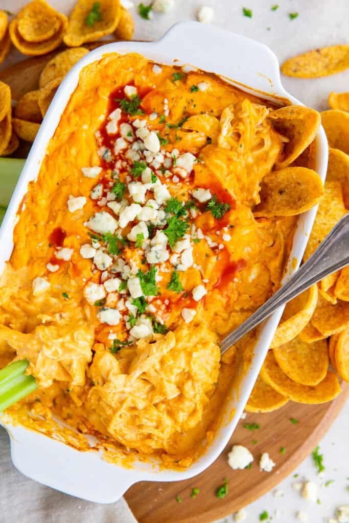 An over the top shot of Buffalo Chicken Dip topped with green onion and blue cheese.