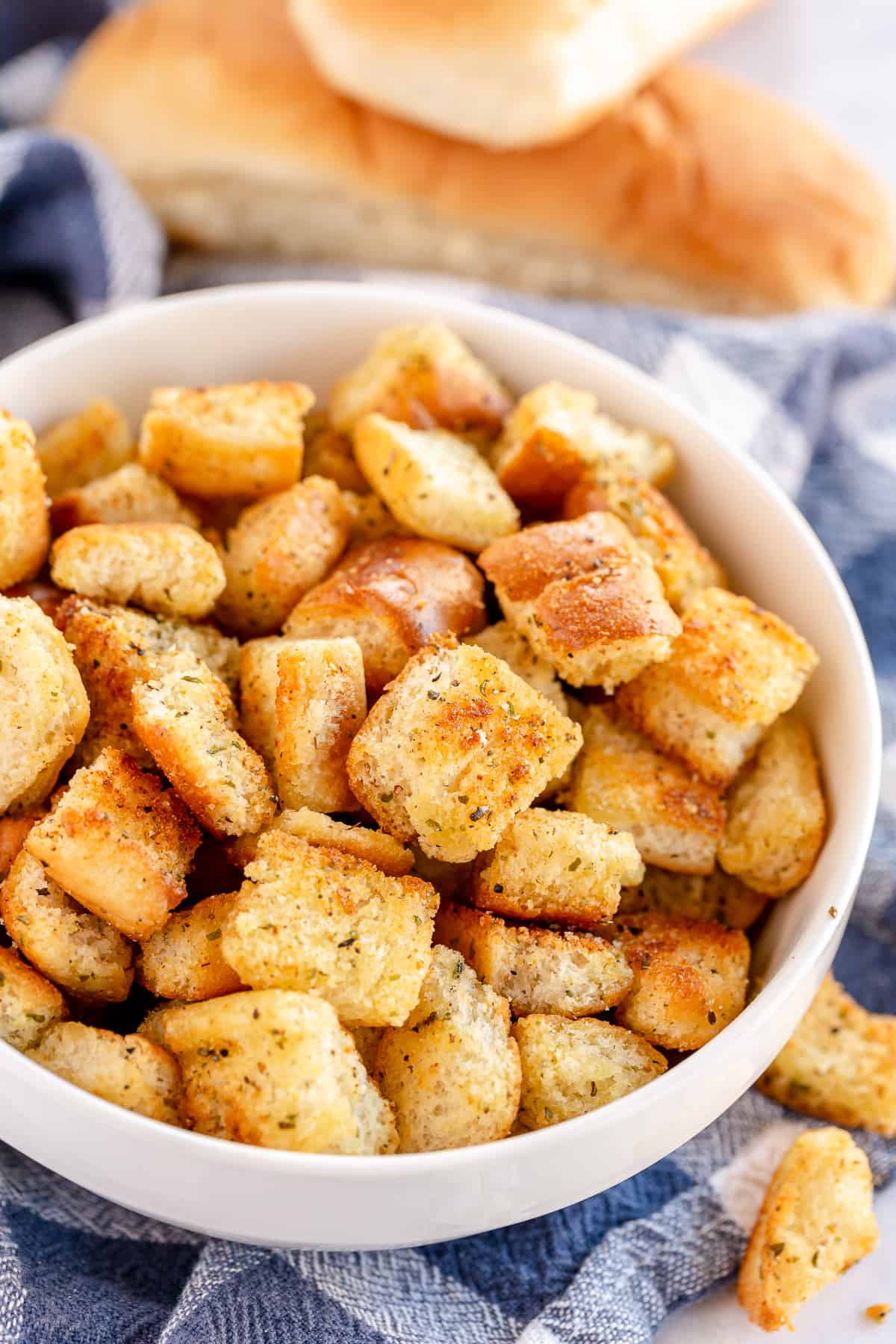 Croutons made with leftover hot dog buns in a white bowl.