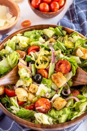 An Italian Salad with olives, tomatoes, onions and croutons.
