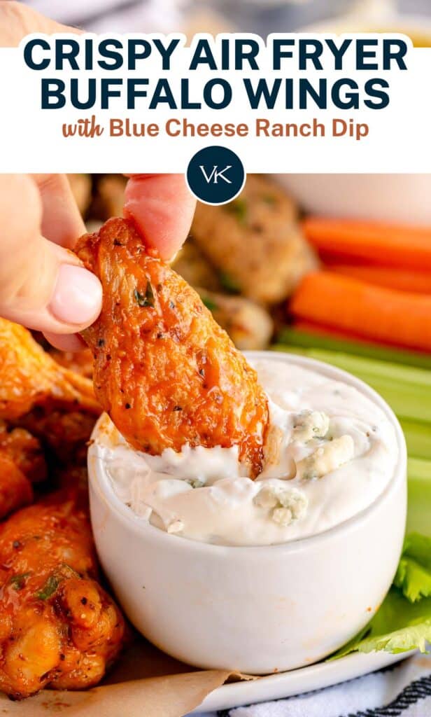 A buffalo wing being dipped in blue cheese ranch dip with overlay text.