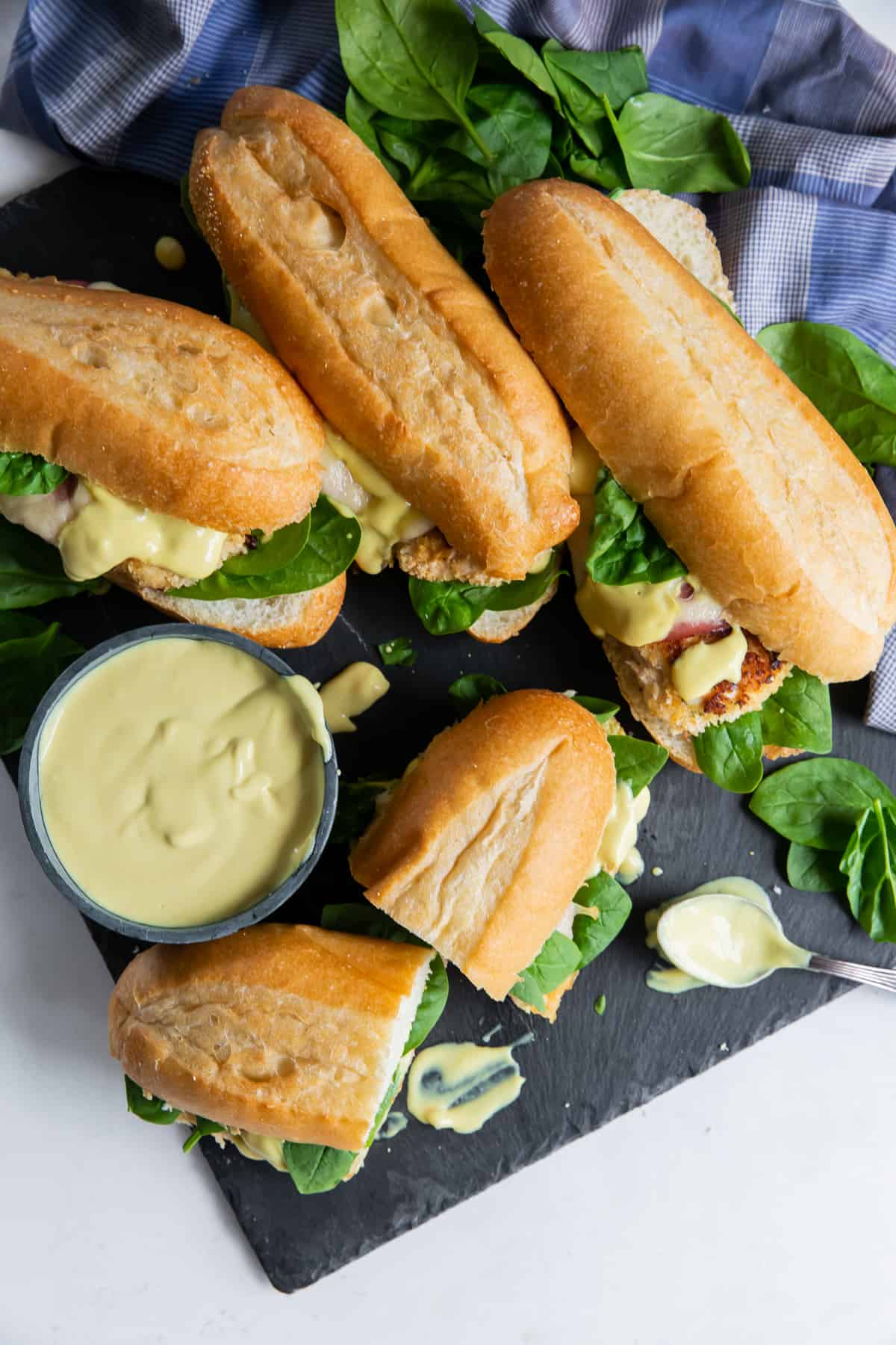 Chicken, ham and swiss sandwiches with spinach with honey mustard sauce.