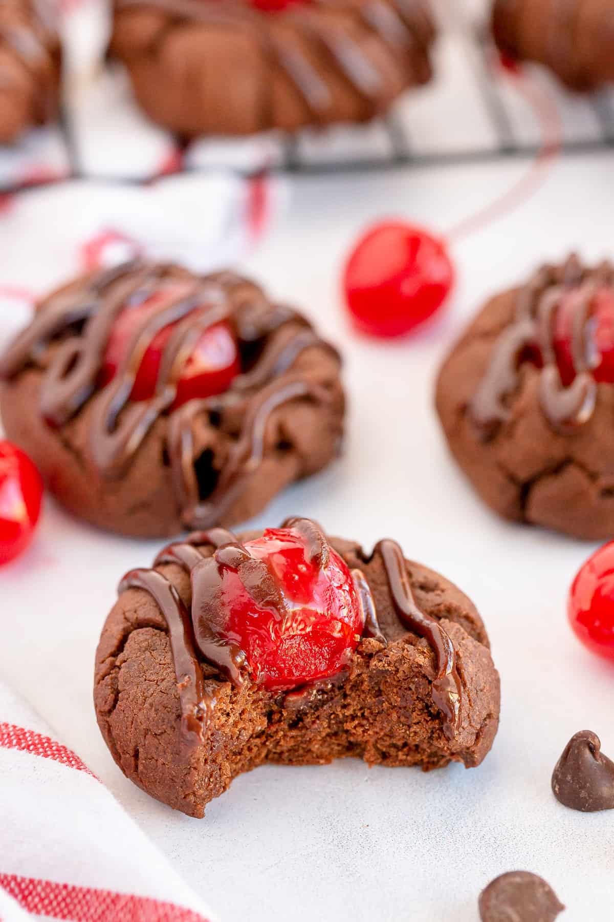A chocolate cherry cookie with a bite missing.