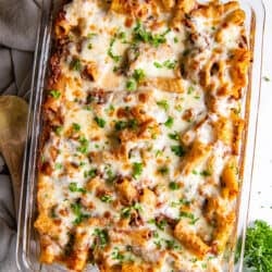 An over the top shot of baked rigatoni in a casserole dish.