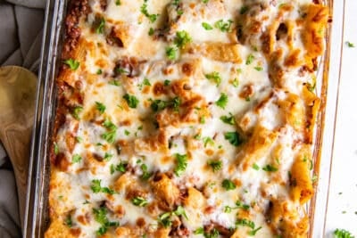 An over the top shot of baked rigatoni in a casserole dish.