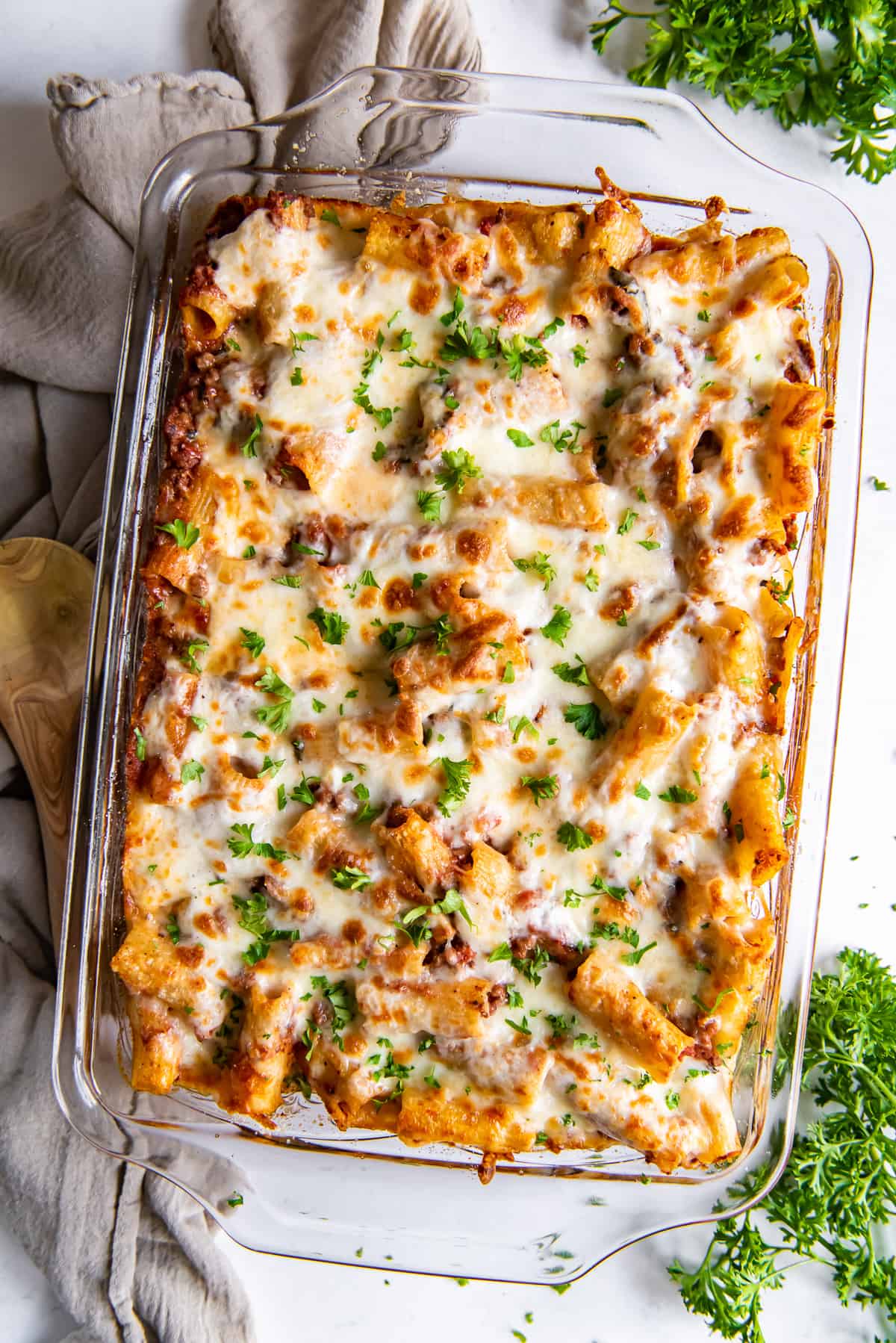 An over the top shot of baked rigatoni in a casserole dish.