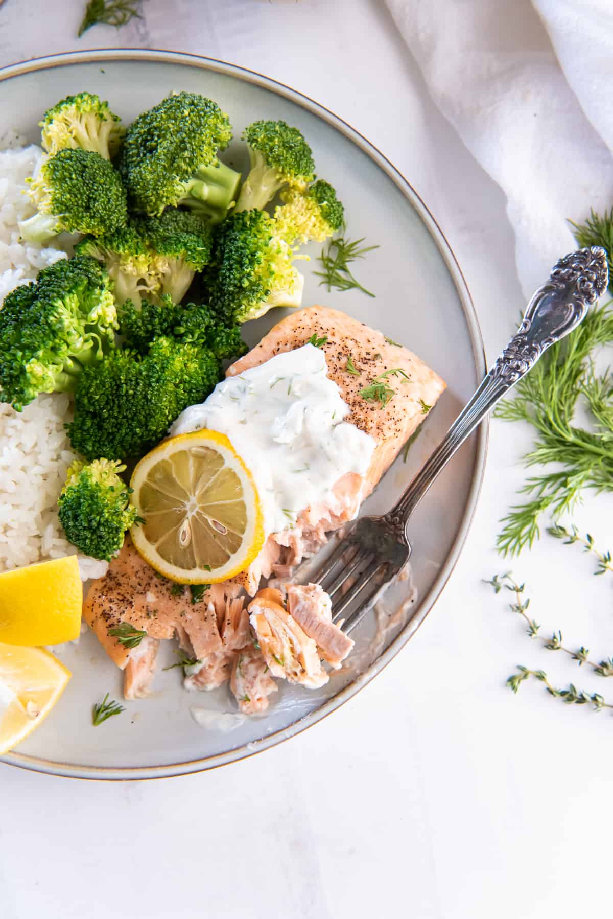 A top down shot of salmon on a plate with a fork.