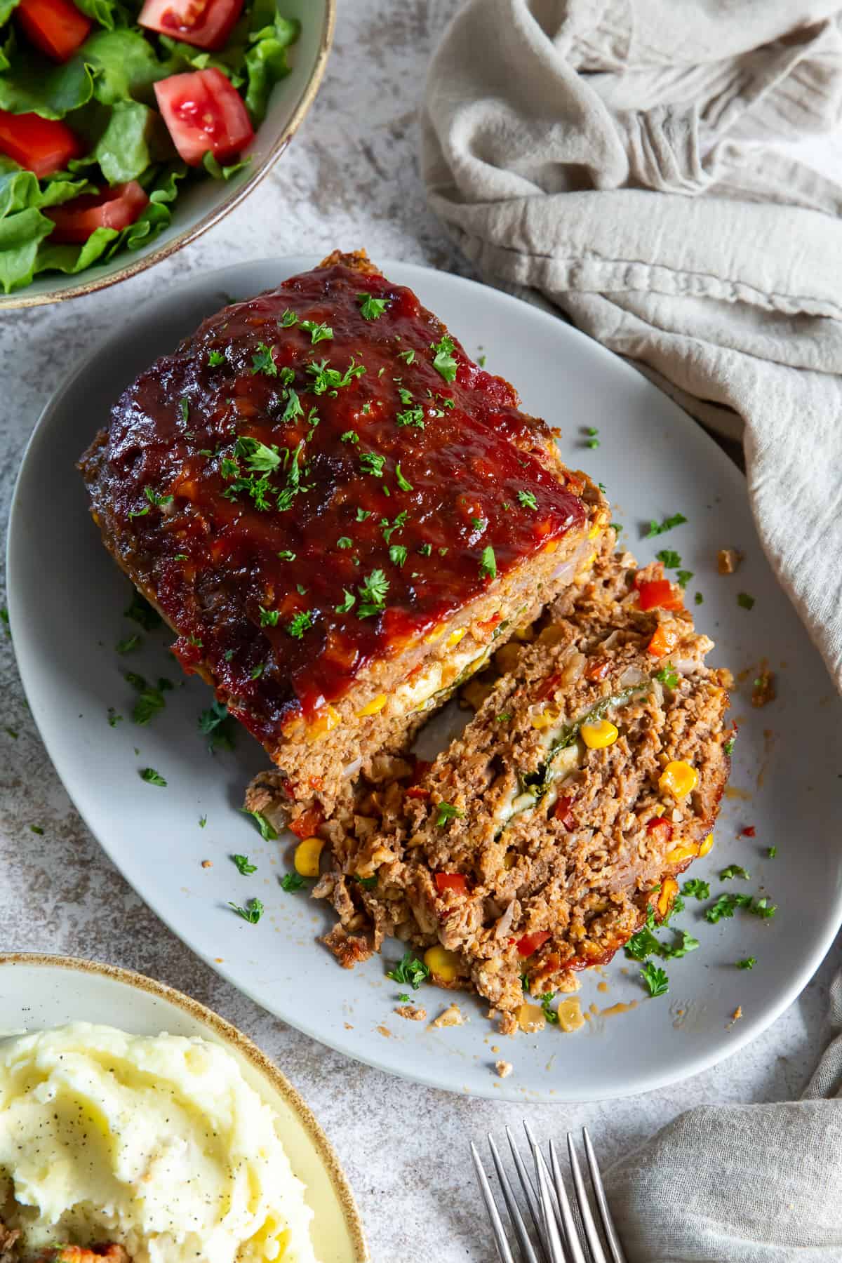An over the top shot of a sliced cheese stuffed meatloaf.