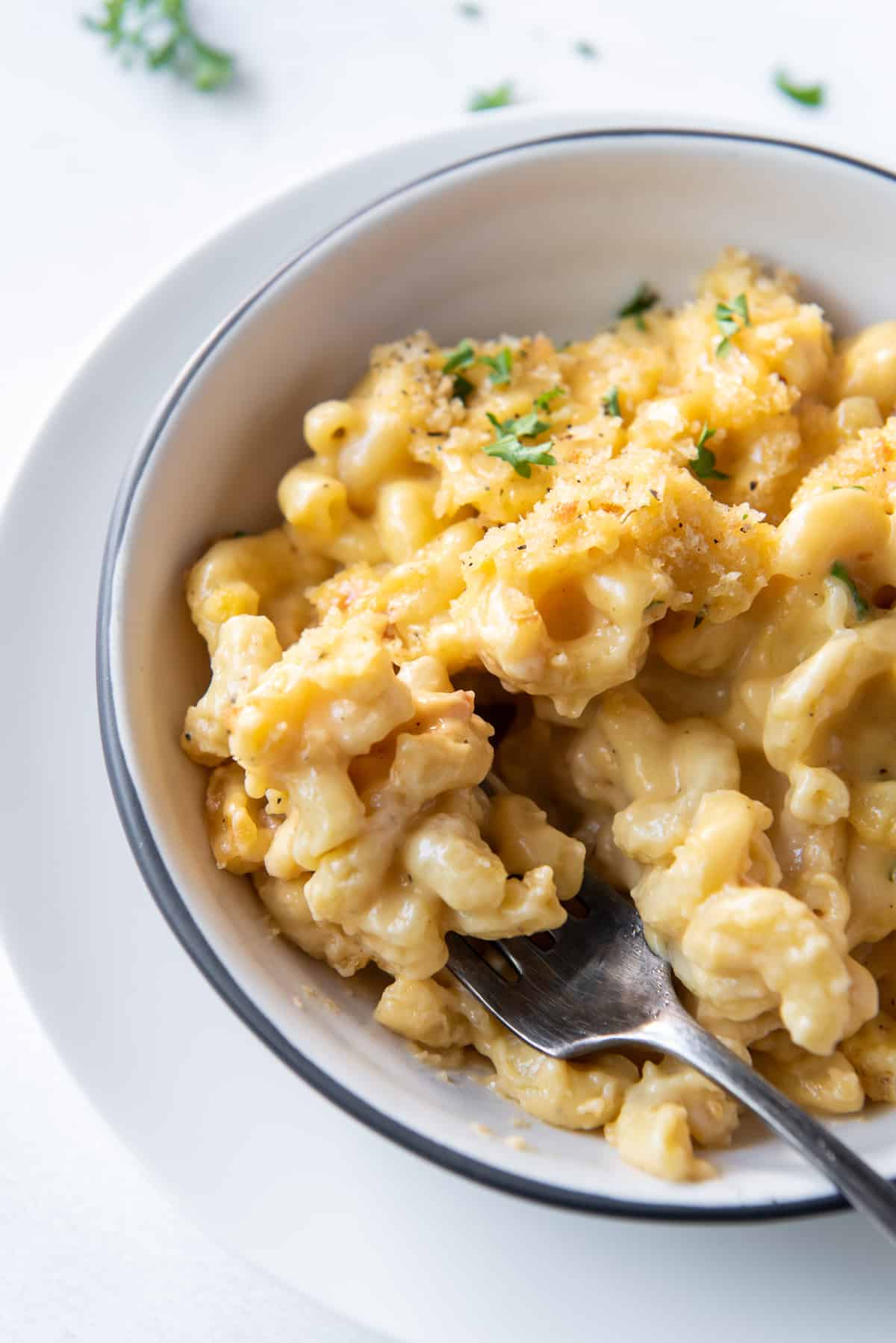Macaroni and cheese in a bowl with a fork.