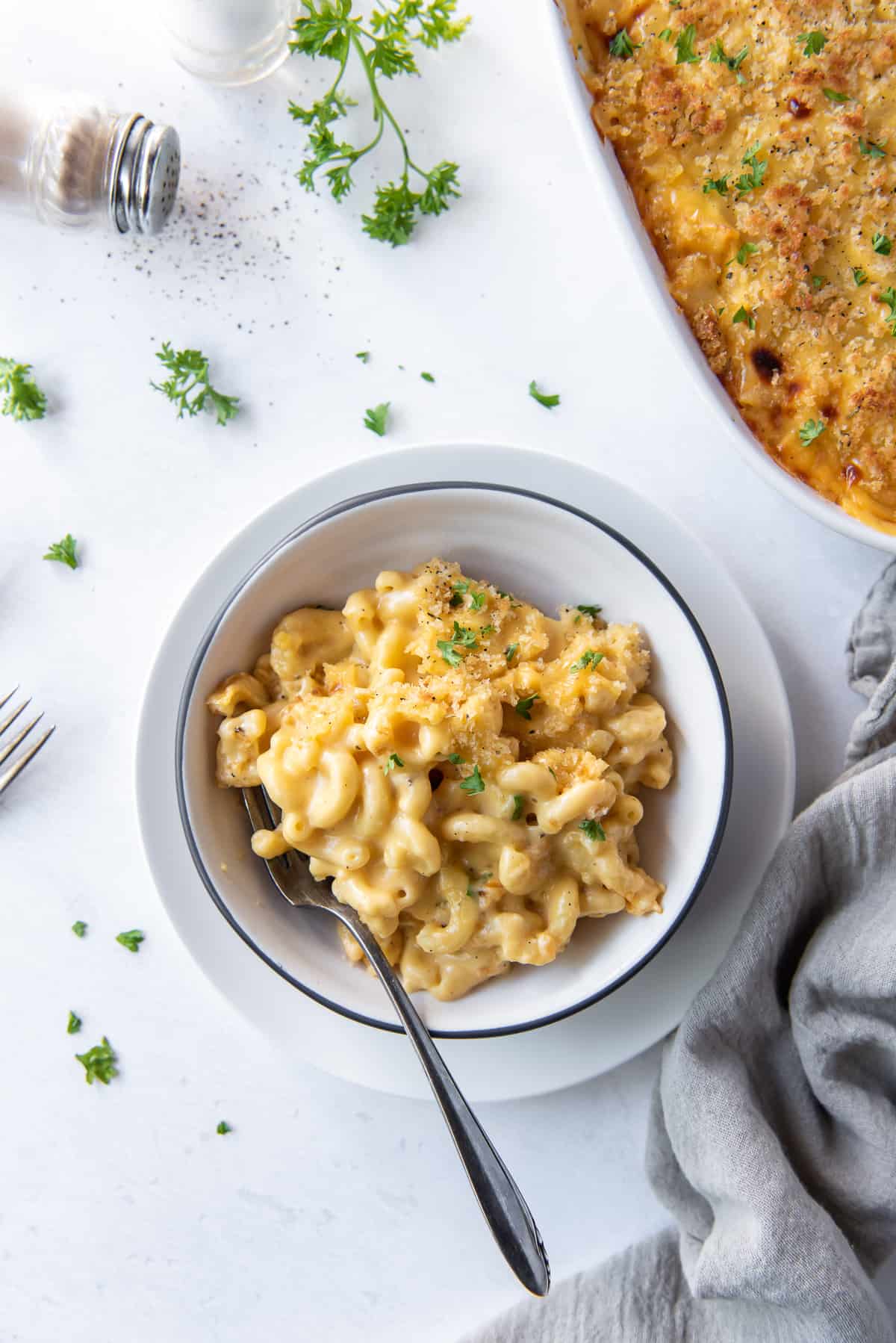 A top down shot of a bowl of macaroni and cheese with a fork.