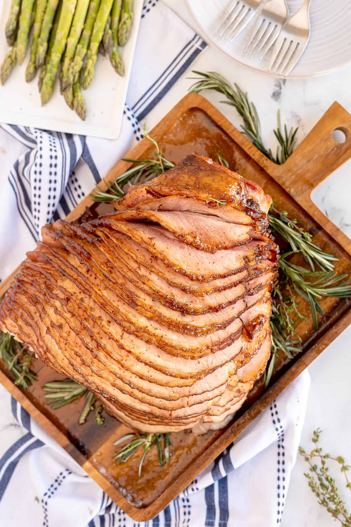 A top down shot of sliced ham on a cutting board.