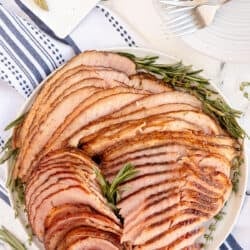 A top down shot of a platter of sliced ham.