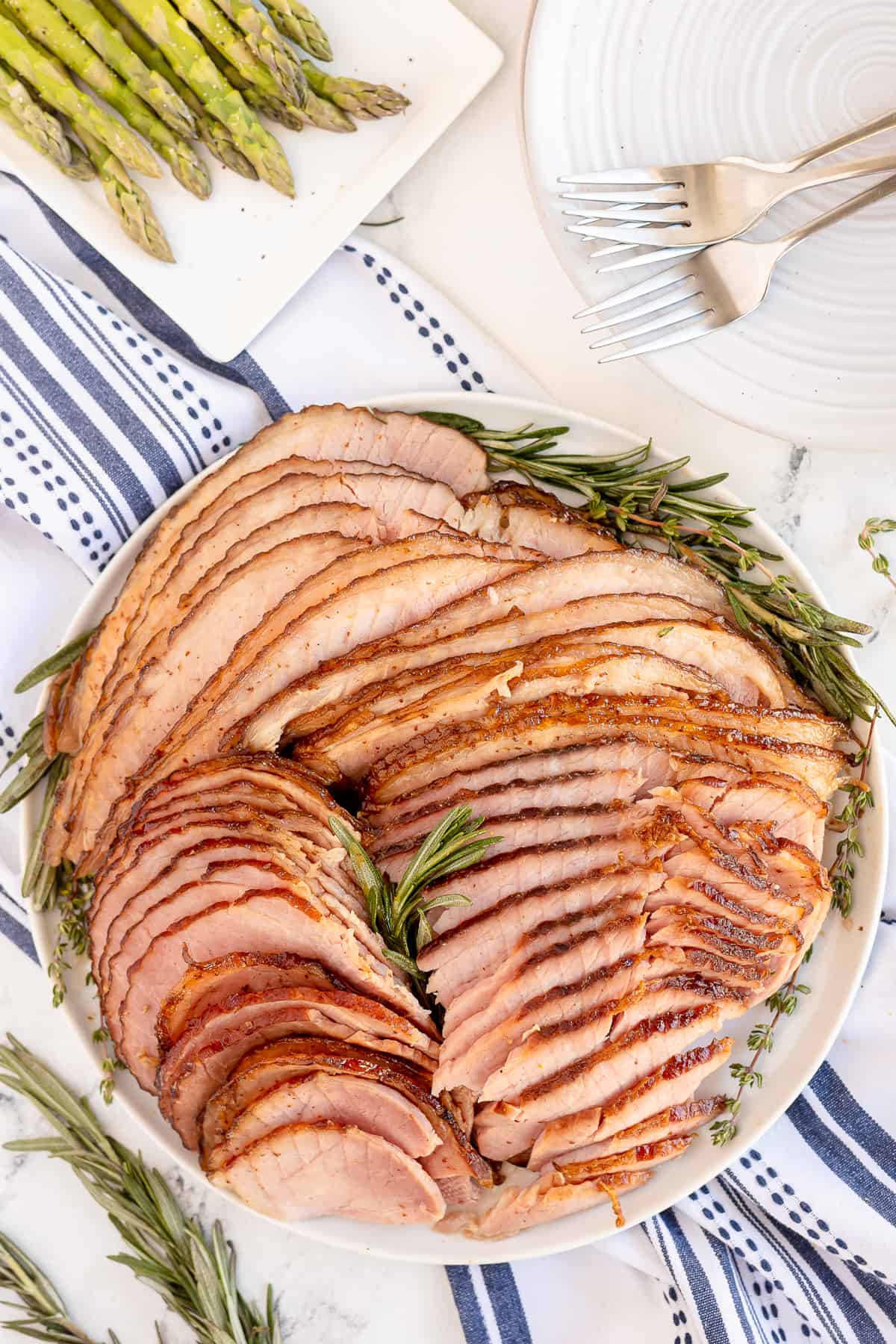 A top down shot of a platter of sliced ham.