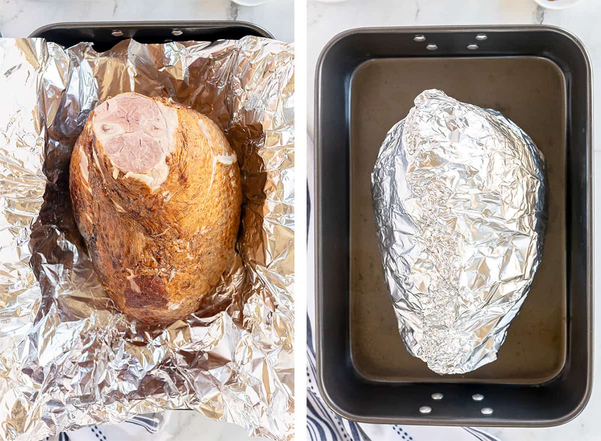 A ham is wrapped in foil in a roasting pan.