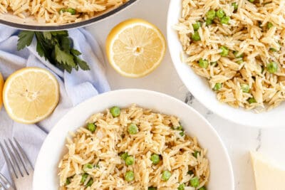 Orzo with Peas and Parmesan in a skillet and two bowls.
