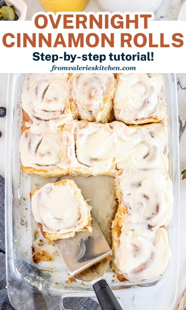 A baking dish full of cinnamon rolls with text.