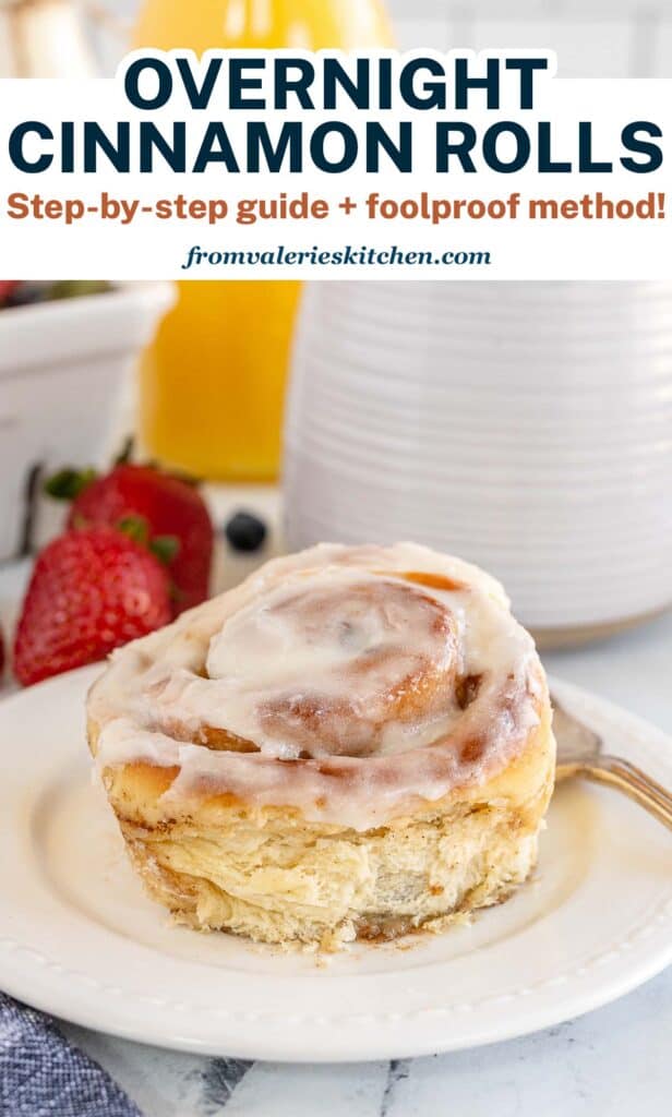 A cinnamon roll on a plate with text.