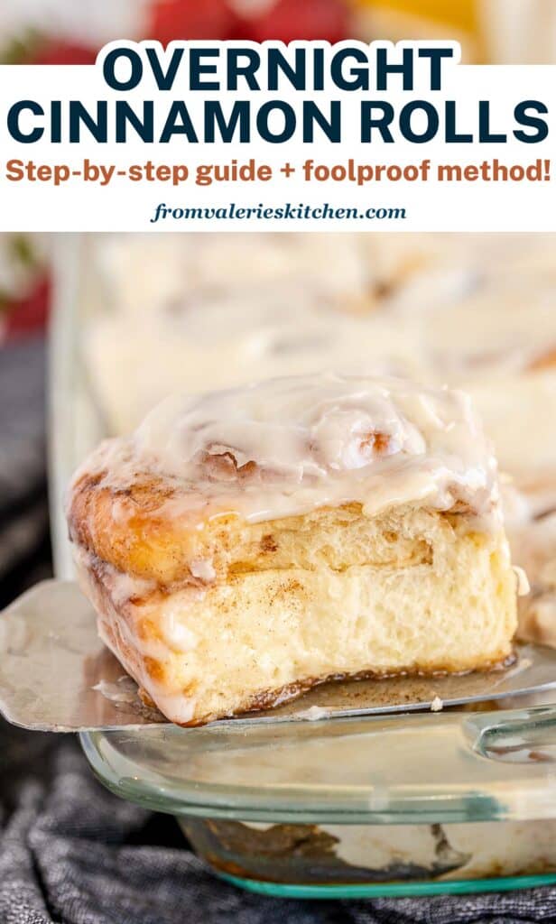 A spatula lifts a cinnamon roll with text.