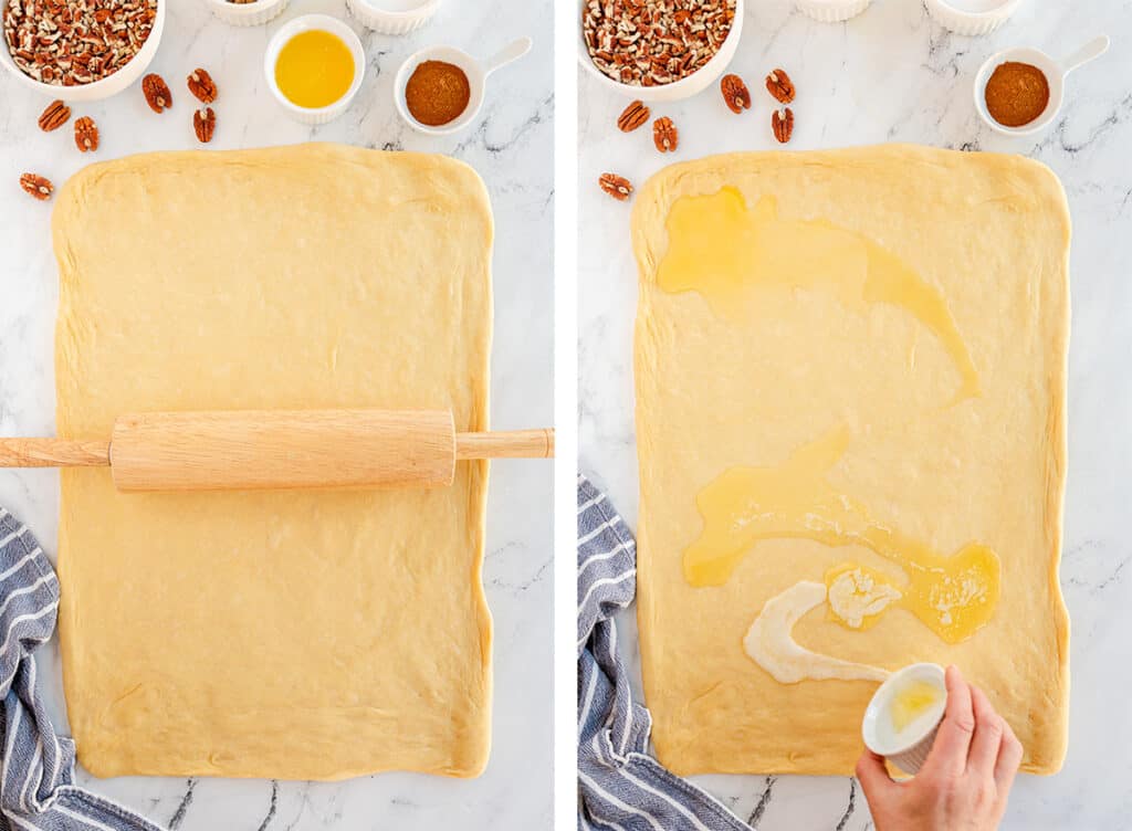 A rolling pin resting on top of dough and melted butter poured over dough.