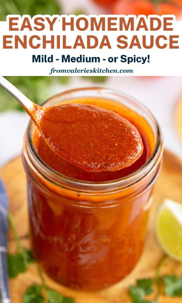 A spoon lifts a scoop of enchilada sauce from a mason jar with text.