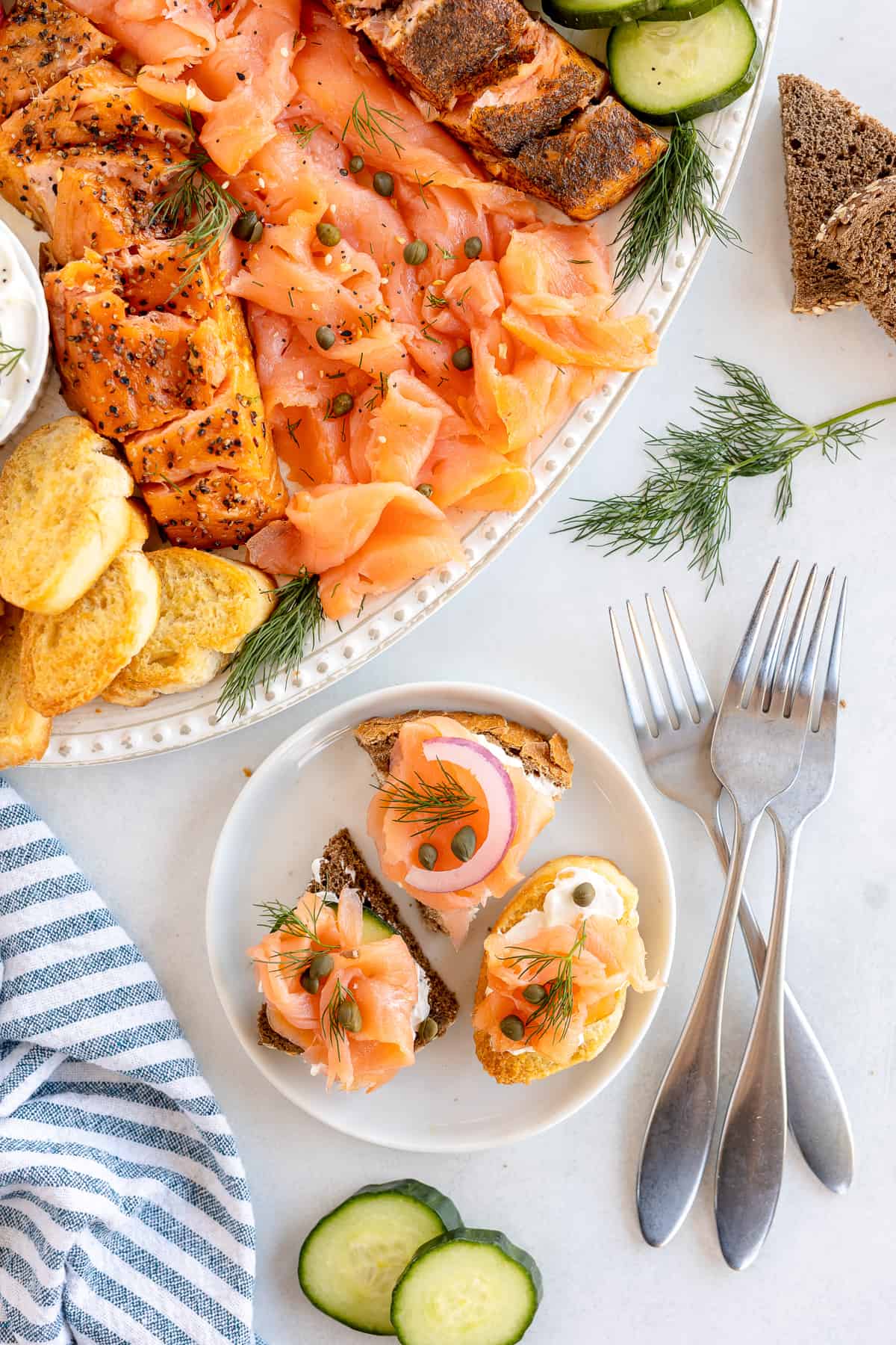 A plate of crostini topped with cream cheese, smoked salmon and capers.