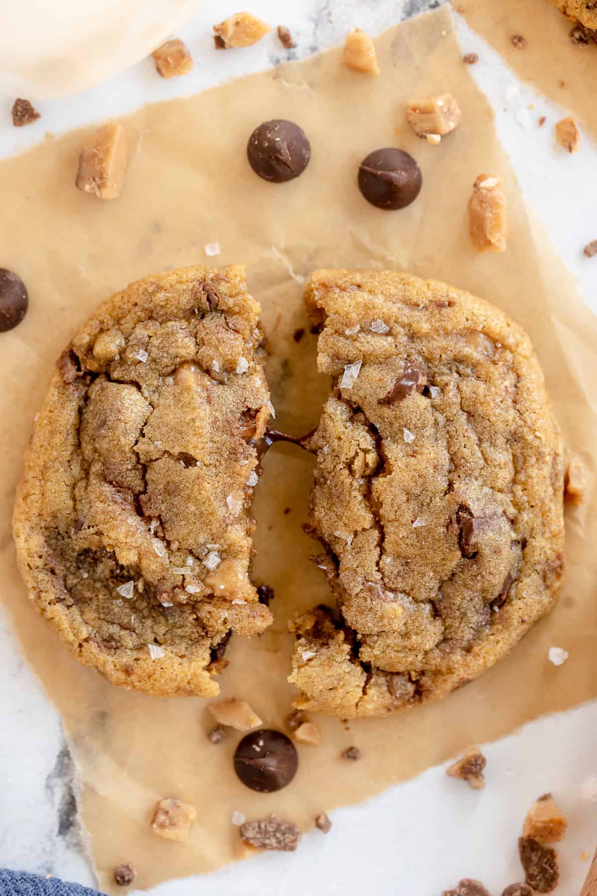 A cookie broken in half with melted chocolate in the middle.