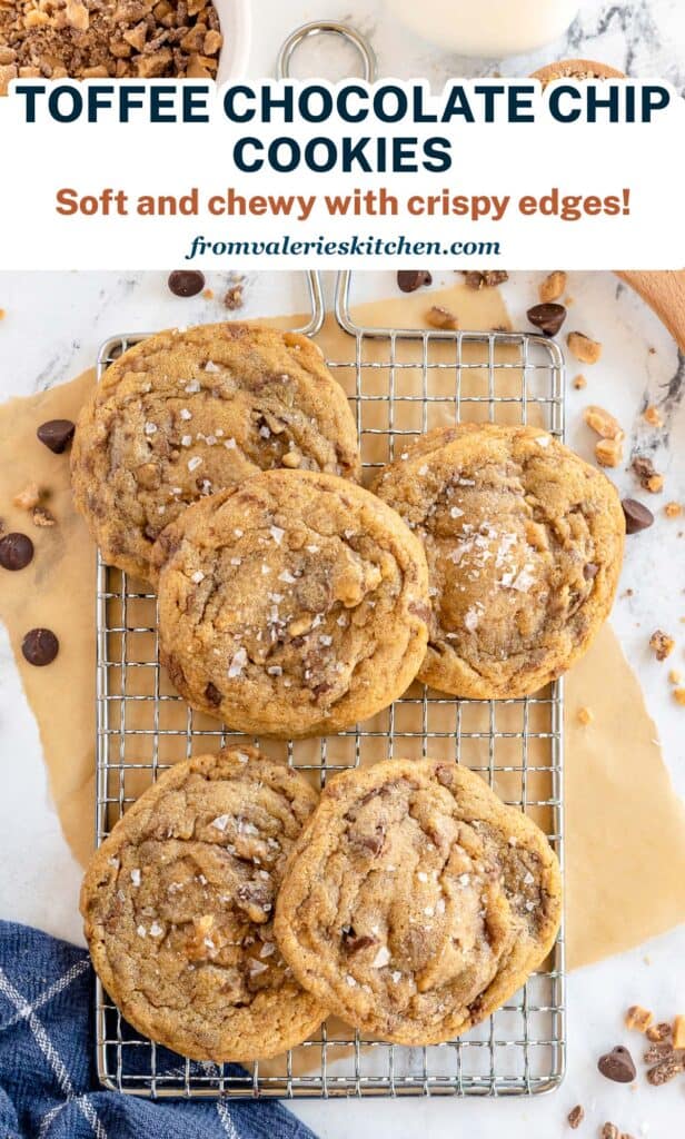 A pile of cookies on a wire rack surrounded by toffee and chocolate chips with text.