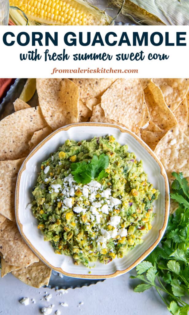 A top down shot of a bowl of corn guacamole surrounded by tortilla chips and sweet corn with text.