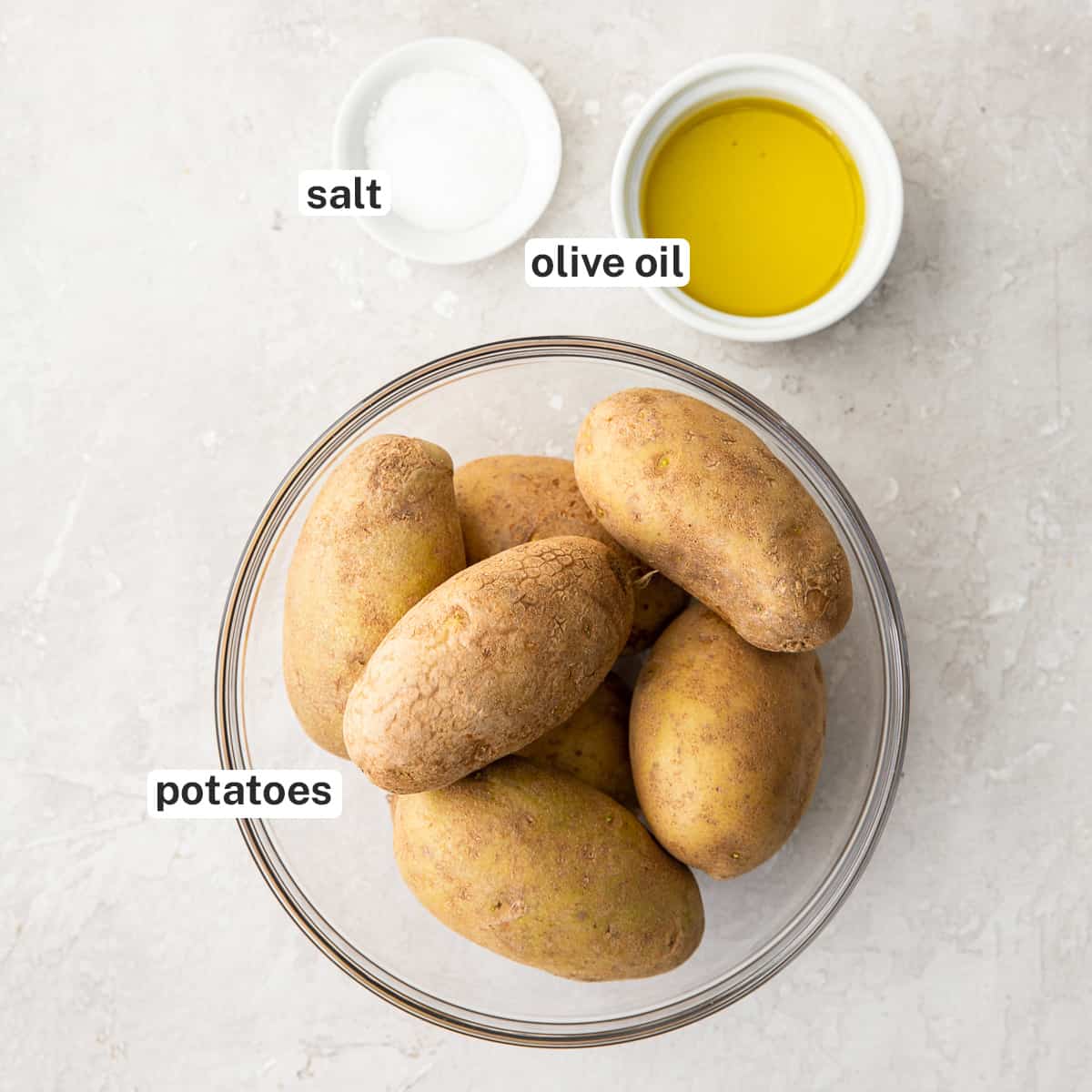 Potatoes, salt, and olive oil in 3 bowls.