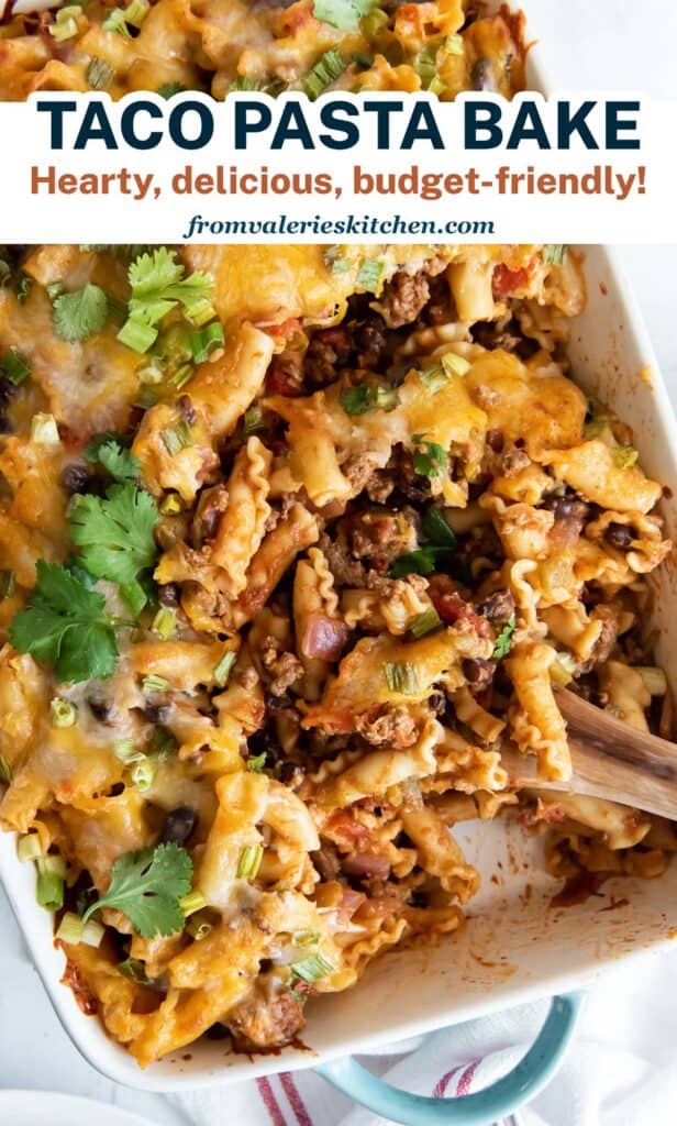 A wooden spoon resting in a baking dish with Taco Pasta with text.