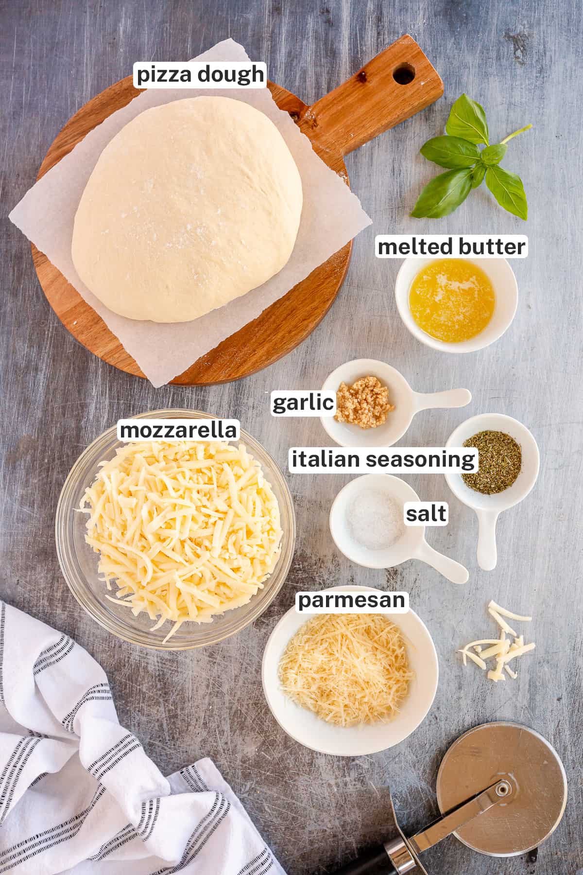 Pizza dough with other ingredients for making Homemade Cheesy Breadsticks with text titles.